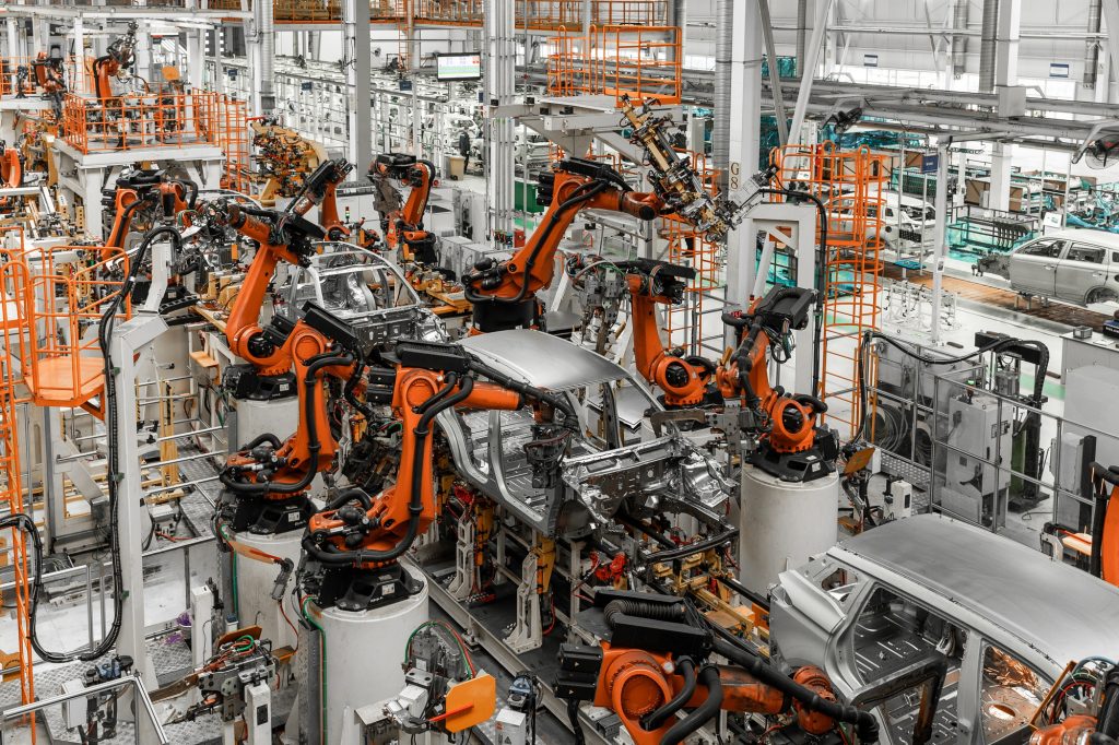 Car bodies are on assembly line. Factory for production of cars. Modern automotive industry